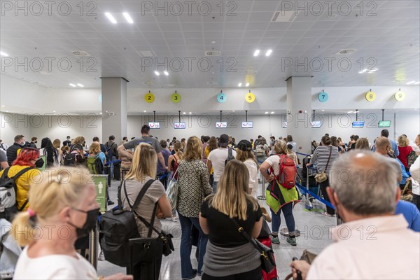 Tourists waiting at the counter in the airport