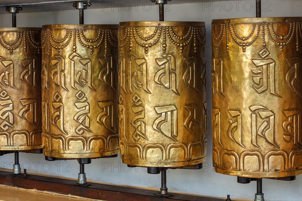 Metal buddhist prayer wheels in Tsuglagkhang complex in Dalai Lama residence