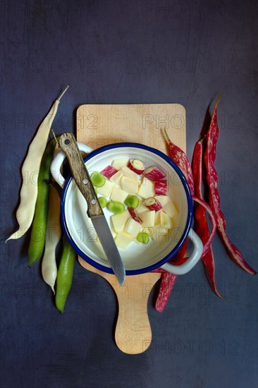 Assorted beans in pot with knife