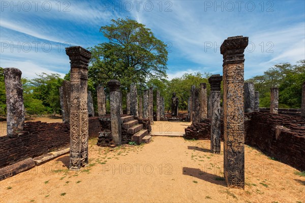 Standing Buddha statue in ancient ruins