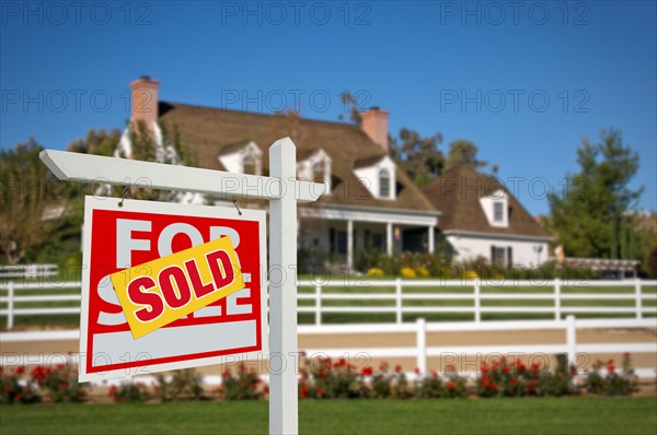 Sold home for sale real estate sign in front of new house