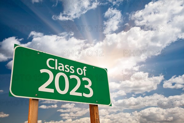 Class of 2023 green road sign with dramatic clouds and sky