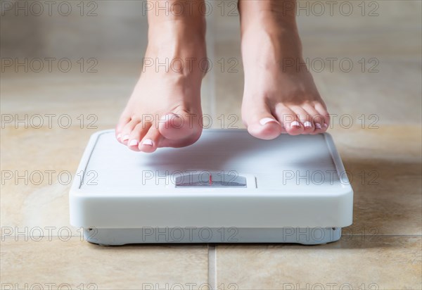 Woman floating slightly above surface of weight scale