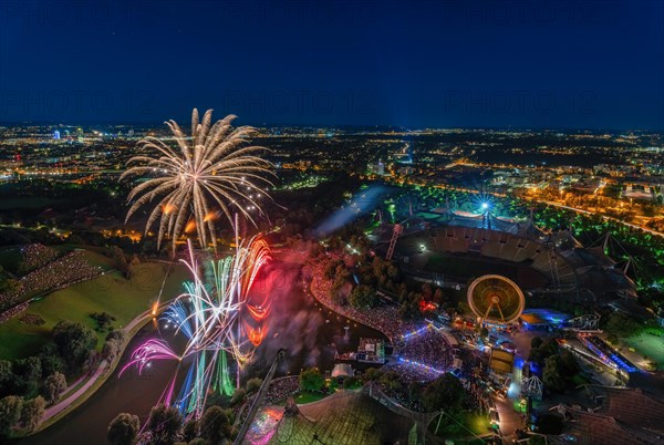 Fireworks over Munich from a high position. The illuminated Olympic Park at night with view from the Olympic Tower