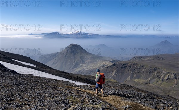 Hikers on hiking trail through volcanic landscape