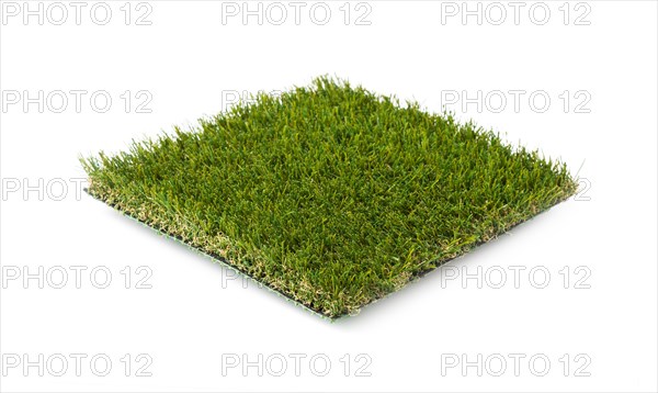 Section of artificial turf grass isolated on white background