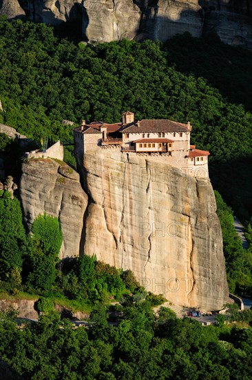 Monastery of Rousanou perched on a cliff in famous greek tourist destination Meteora in Greece on sunset with scenic landscape