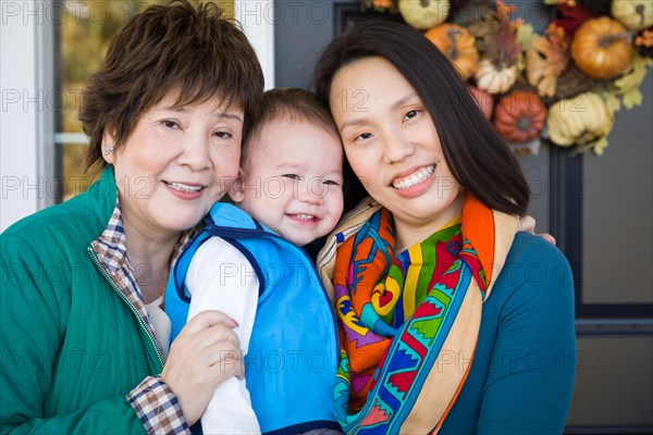 Happy chinese senior adult grandmother with her daughter and grandson