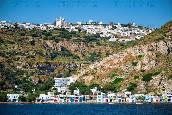 Klima and Plaka villages with whitewhashed traditional houses and orthodox church and windmills on Milos island