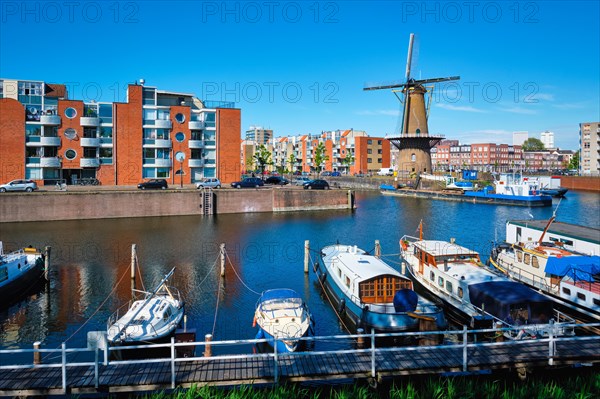 View of the harbour of Delfshaven with the old grain mill known as De Destilleerketel