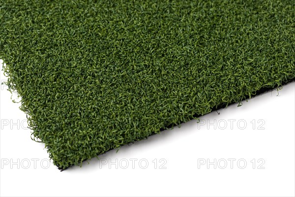 Section of artificial turf grass on white background