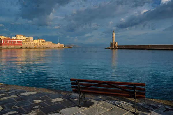 Bench in picturesque old port of Chania is one of landmarks and tourist destinations of Crete island in the morning on sunrise. Chania