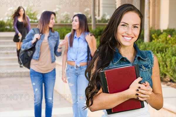 mixed-race young girl student with school books on campus