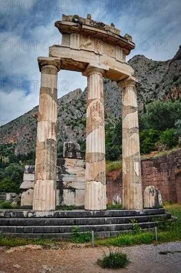 Tholos with Doric columns at the sanctuary of Athena Pronoia temple ruins in ancient Delphi