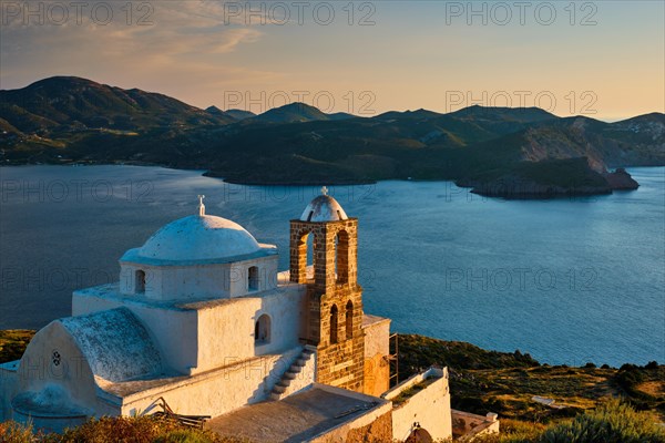 Traditional whitewashed Greek Orthodox church in Plaka village on Milos island on sunset. Milos island