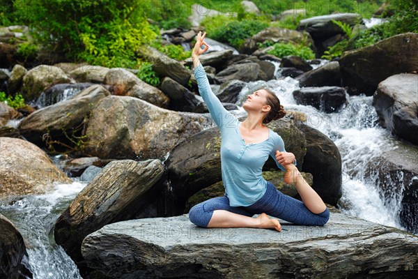 Young sporty fit woman doing yoga asana Eka pada rajakapotasana