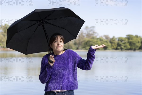 Latin woman with umbrella on a sunny day