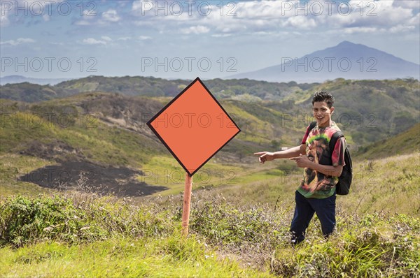 A guy pointing at a billboard