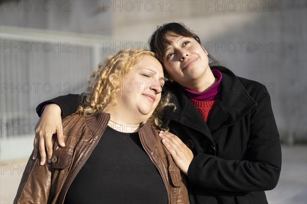 Couple of lesbian women hugging in a park