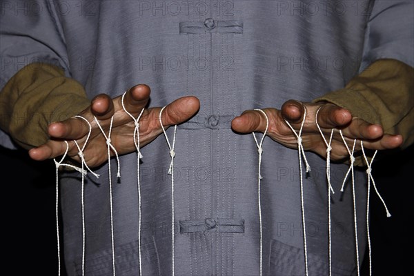 String-pulling puppeteer with Chinese shirt