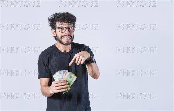 Man pointing at the money in his hand