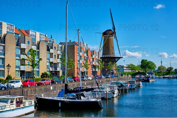 View of the harbour of Delfshaven with the old grain mill known as De Destilleerketel