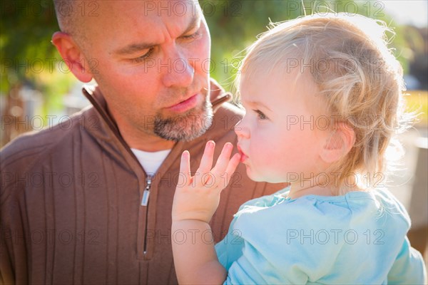 Adorable young family enjoys a day at the pumpkin patch