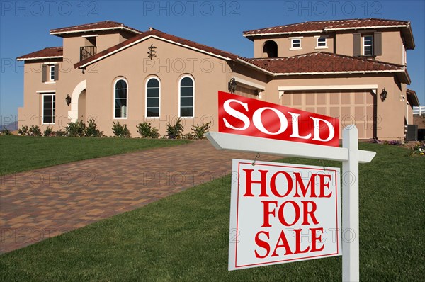 Sold home for sale sign in front of new house