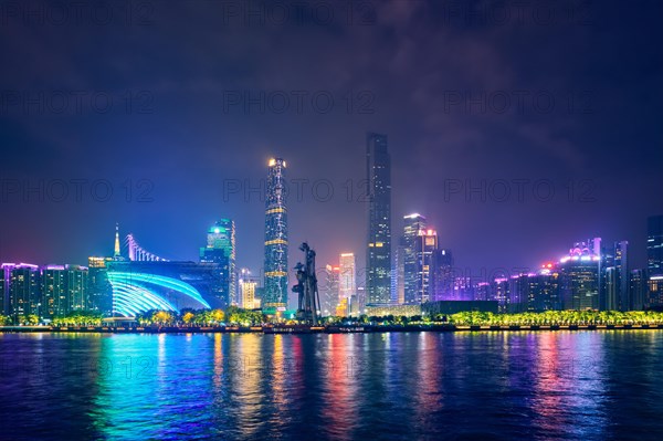 Guangzhou cityscape skyline over the Pearl River illuminated in the evening. Guangzhou