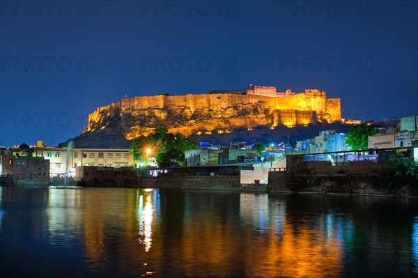 Famous indian tourist landmark Mehrangarh fort in the evening view over Gulab Sagar lake. Jodhpur