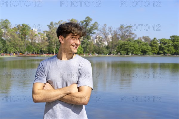 Portrait of confident young blond man with crossed arms looking at camera