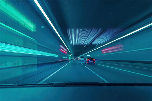 Highspeed in the tunnel. View through the driver's windscreen of a car as a long exposure with light pullers and racing feeling