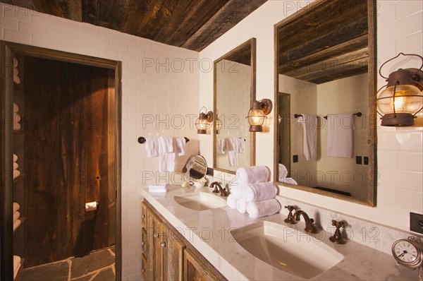 Luxurious rustic bathroom with mining lamps in spa setting