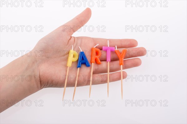 Color candles in hand on sticks write the word party
