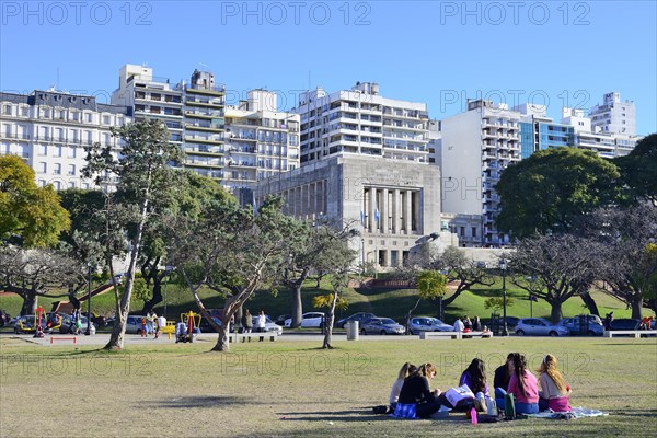 People in the park in front of the flag monument