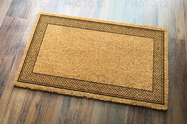 Blank welcome mat on wood floor background ready for your own text