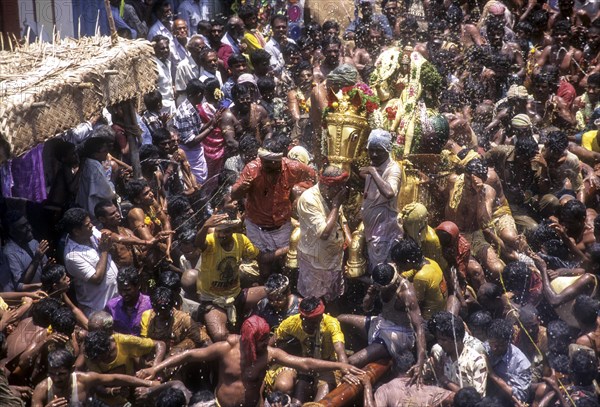 Ritual spraying of water on Lord Kallazhagar or Vishnu mounted on golden horse in Chitra or Chithirai festival in Madurai