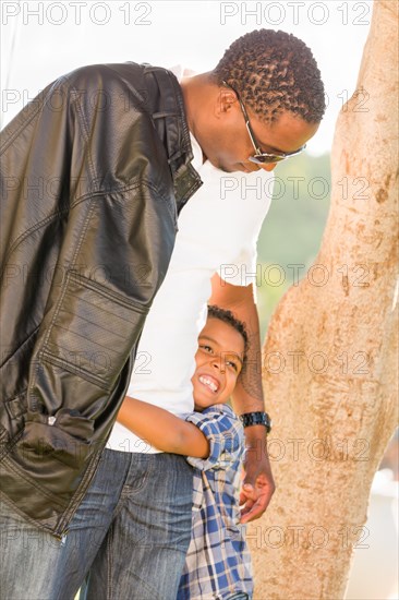 Happy african american father and mixed-race son playing at the park