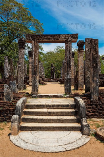 Standing Buddha statue in ancient ruins