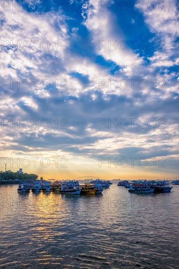 Tourist boats in sea on sunrise in Mumbai