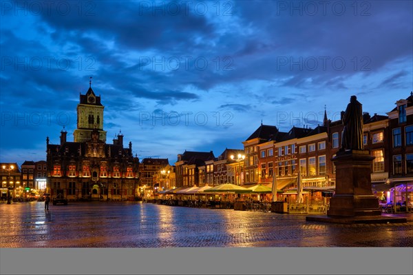 Delft City Hall and Delft Market Square Markt with Hugo de Groot Monument in the evening