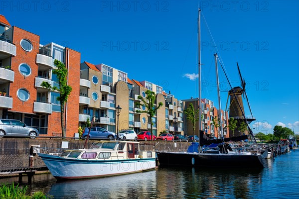 View of the harbour of Delfshaven with the old grain mill known as De Destilleerketel