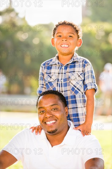 Happy african american father and mixed-race son playing at the park