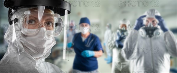 Team of female and male doctors or nurses wearing personal protective equipment in hospital emergency room