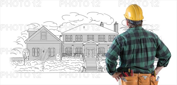 Male contractor with hard hat and tool belt looking at custom house drawing on white