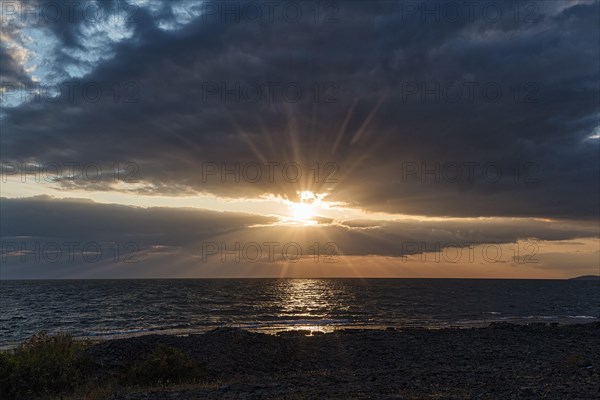 Sunbeams through gap in clouds