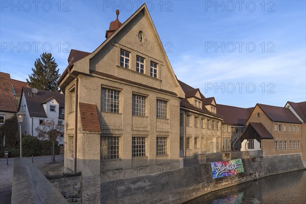 Historic main building of a former valve factory in the evening light