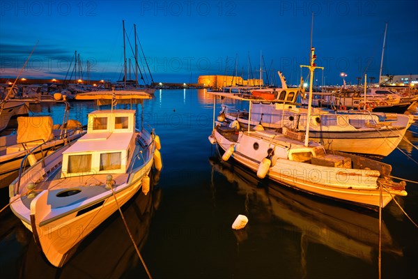 Venetian Fort Venetian fortress of Koules Castello a Mare castle in Heraklion and moored Greek fishing boats in port