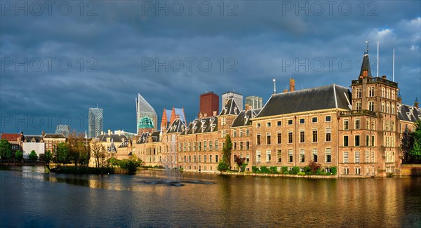 Panorama of the Binnenhof House of Parliament and the Hofvijver lake with downtown skyscrapers in background