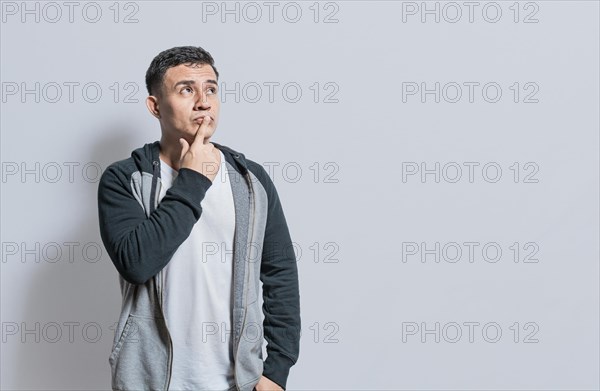 Person wondering with hand on chin isolated